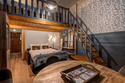 a bedroom with two beds and a staircase at Superbe appartement hyper-centre in Chamonix-Mont-Blanc