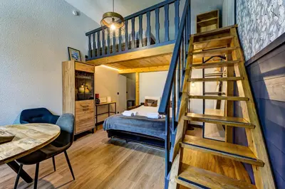 a bedroom with a bunk bed and a staircase in a room at Superbe appartement hyper-centre in Chamonix-Mont-Blanc