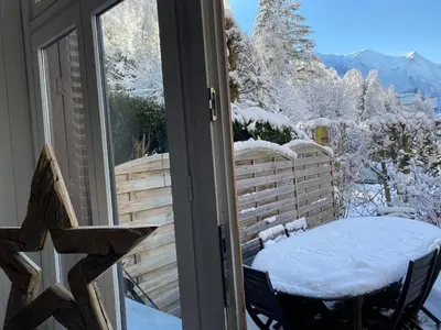 a table and chairs on a balcony with snow at Mer de Glace in Chamonix-Mont-Blanc