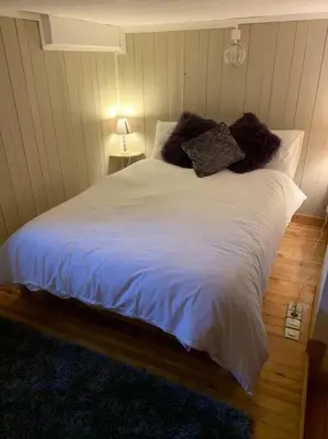 a large white bed with pillows on it in a bedroom at Mer de Glace in Chamonix-Mont-Blanc