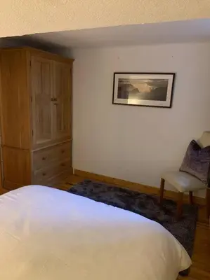 a bedroom with a white bed and a chair at Mer de Glace in Chamonix-Mont-Blanc