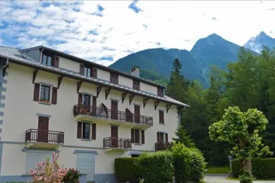 a building with balconies and mountains in the background at Mer de Glace in Chamonix-Mont-Blanc