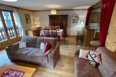 a living room with a table and a couch at Large apartment in Chamonix - close to the slopes in Chamonix-Mont-Blanc