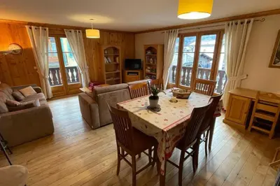 a kitchen with wooden cabinets and a red curtain at Large apartment in Chamonix - close to the slopes in Chamonix-Mont-Blanc