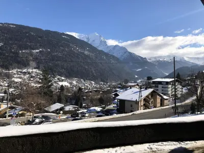 a view of a town with snow covered mountains at Résidence Hameau De Coterat - Hameau de Coterat 11 MAE-2524 in Saint-Gervais-les-Bains