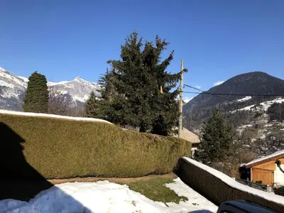 a wall with snow on it with mountains in the background at Résidence Hameau De Coterat - Hameau de Coterat 11 MAE-2524 in Saint-Gervais-les-Bains