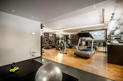 a gym with treadmills and exercise equipment in a room at Chalet Apollo in Megève