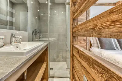 a bathroom with a sink and a shower at Chalet Eisstock in Megève