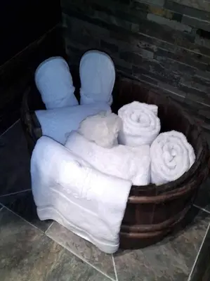 a tub filled with white towels sitting next to a wall at Amour & Chocolat in Sixt