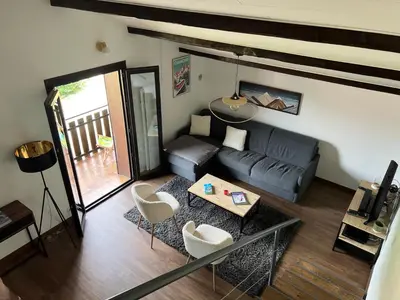 a living room with a couch and a table at Duplex 3 chambres Vue Mont-Blanc in Domancy