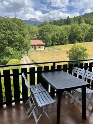a table and two chairs on a balcony with a view at Duplex 3 chambres Vue Mont-Blanc in Domancy