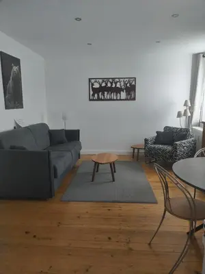 a living room with a couch and a table at LaResidence in Saint-Gervais-les-Bains