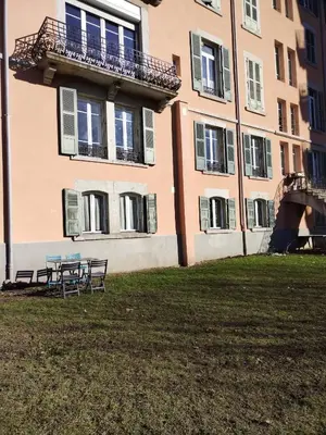 a table and chairs in front of a building at LaResidence in Saint-Gervais-les-Bains