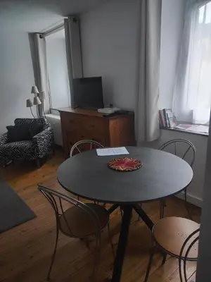 a table and chairs in a living room at LaResidence in Saint-Gervais-les-Bains