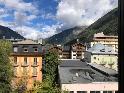 a view of a city with buildings and mountains at Superbe studio refait à neuf et tout équipé avec parking in Chamonix-Mont-Blanc