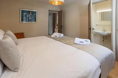 a bedroom with two beds and a window at Chalet le Tricouni in Chamonix-Mont-Blanc