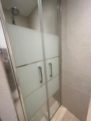 a shower with a glass door in a bathroom at Residencecalou in Saint-Gervais-les-Bains