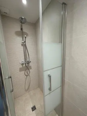 a shower with a glass door in a bathroom at Residencecalou in Saint-Gervais-les-Bains