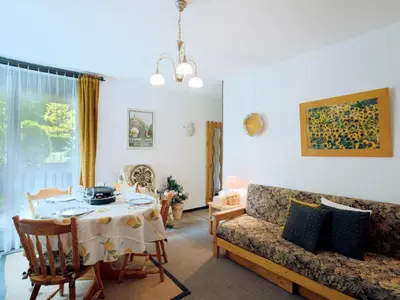 a living room with a table and a couch at Apartment Castel des Roches C4 by Interhome in Saint-Gervais-les-Bains