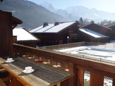 a house with a swimming pool in front of a mountain at Apartment Les G'rets-12 by Interhome in Saint-Gervais-les-Bains