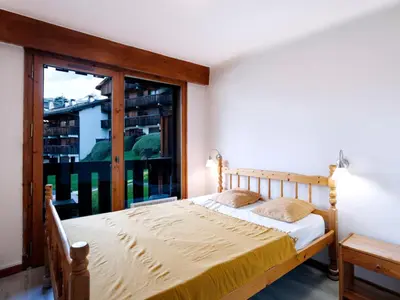 two bunk beds in a room with a door at Apartment Les G'rets-12 by Interhome in Saint-Gervais-les-Bains