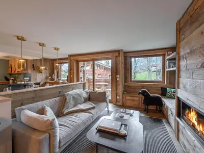 a living room with a couch and a fireplace at Duplex rénové au cœur de Megève, 3 chambres, cheminée, terrasse, équipements modernes. - FR-1-569-72 in Megève