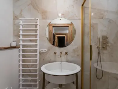 a bathroom with a sink and a mirror at Duplex rénové au cœur de Megève, 3 chambres, cheminée, terrasse, équipements modernes. - FR-1-569-72 in Megève