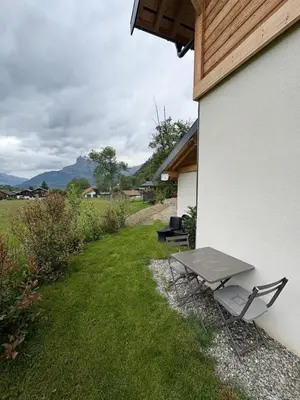 a picnic table and a bench next to a building at Charmant studio Saint Gervais 74 in Saint-Gervais-les-Bains