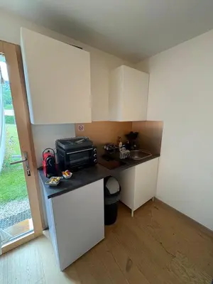 a small kitchen with a counter and a microwave at Charmant studio Saint Gervais 74 in Saint-Gervais-les-Bains