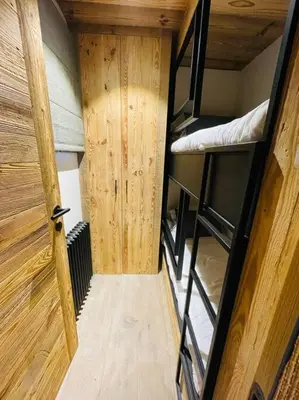 a small room with two bunk beds and a door at Romy appartement centre village in Megève