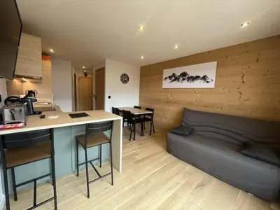 a kitchen and a living room with a bed and a table at Charmant Studio-Cabine 4 pers, Centre-Village, Balcon Ouest, à 600m des Pistes - FR-1-572-281 in Arâches-la-Frasse
