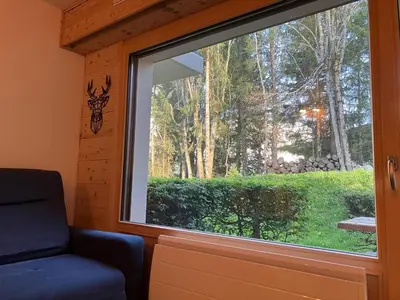 a window in a room with a chair in front of it at Le cocon du Bettex 1400 - Cozy Apt near Mont Blanc in Saint-Gervais-les-Bains