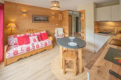 a living room with a couch and a table at Le Cristal du Mont-Blanc in Saint-Gervais-les-Bains