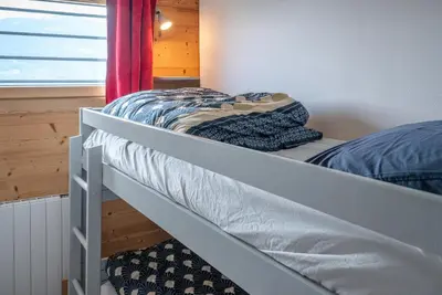 a bunk bed in a room with a window at Le Cristal du Mont-Blanc in Saint-Gervais-les-Bains