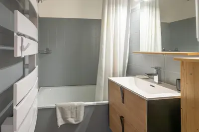 a bathroom with a sink and a bath tub at Le Cristal du Mont-Blanc in Saint-Gervais-les-Bains