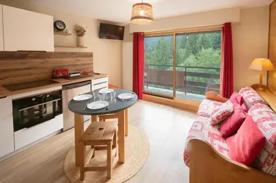 a living room with a couch and a table at Le Cristal du Mont-Blanc in Saint-Gervais-les-Bains