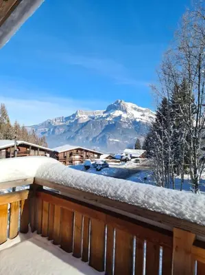 a snow covered balcony with a view of a mountain at Chalet de luxe sur les pistes - 5 chambres in Combloux
