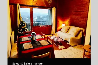 a living room with a christmas tree and a couch at Appartement cosy à Samoëns de 57 m² avec balcon. in Samoëns