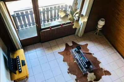 a room with a smashed up floor with a window at Appartement cosy à Samoëns de 57 m² avec balcon. in Samoëns