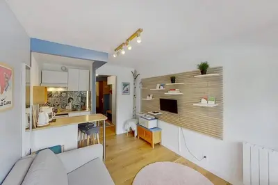 a living room with a couch and a kitchen at Studio moderne de 18m2 aux carroz d'arâches in Les Carroz d'Araches