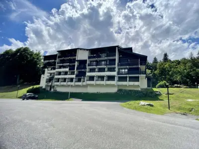 a large building on the side of a road at Studio moderne de 18m2 aux carroz d'arâches in Les Carroz d'Araches