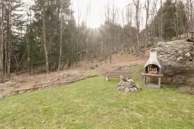 a park with a bench and a small house at Betulle - 2bedroom - Patio facing Mont-Blanc range in Les Houches