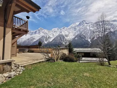 a house with a view of snow covered mountains at Betulle - 2bedroom - Patio facing Mont-Blanc range in Les Houches
