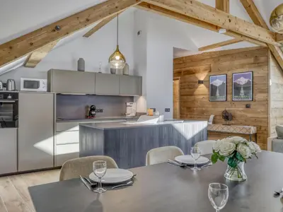 a kitchen and dining room with a table and chairs at Appartement accueillant 6 pers, proche centre et télécabine, wifi inclus - FR-1-663-19 in Saint-Gervais-les-Bains