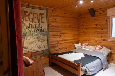 a bedroom with a bed in a log cabin at Gîte Ferme Sixt-Fer-à-Cheval in Sixt
