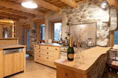 a kitchen with a counter with wine glasses on it at Gîte Ferme Sixt-Fer-à-Cheval in Sixt