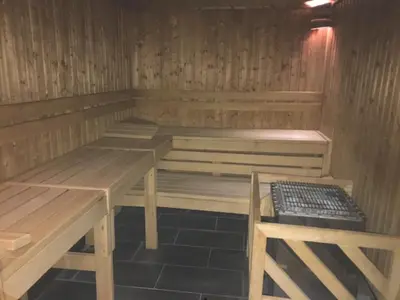 a sauna with wooden tables and benches in a room at Chez Charles I Vallorcine Viachamonix in Vallorcine