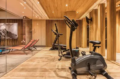 a gym with exercise equipment in a room at Rock and Stars Megève in Megève