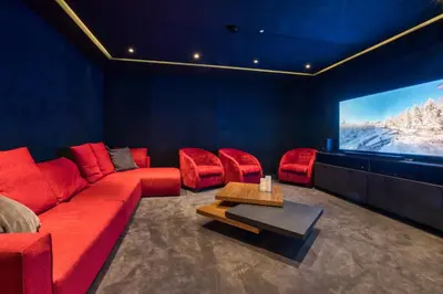 a living room with a red couch and a tv at Rock and Stars Megève in Megève