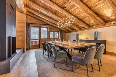 a dining room with a table and chairs at Rock and Stars Megève in Megève